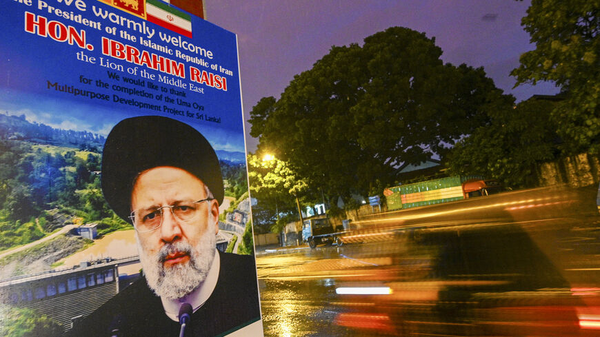 Commuters ride past a welcoming billboard displaying an image of Iran's President Ebrahim Raisi along a street in Colombo on April 23, 2024. Raisi will arrive on April 24 for a one-day official visit to Sri Lanka. (Photo by Ishara S. KODIKARA / AFP) (Photo by ISHARA S. KODIKARA/AFP via Getty Images)