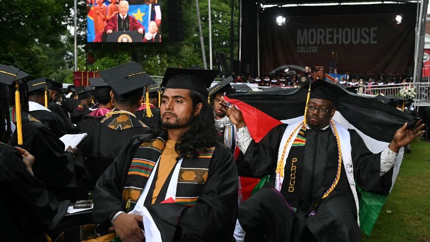 Graduating students turn their back on US President Joe Biden as he delivers a commencement address during Morehouse College's graduation ceremony in Atlanta, Georgia on May 19, 2024