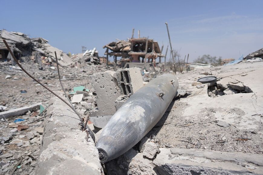 Parts of a missile lie amid debris of buildings destroyed during previous Israeli bombardment in Nuseirat, central Gaza