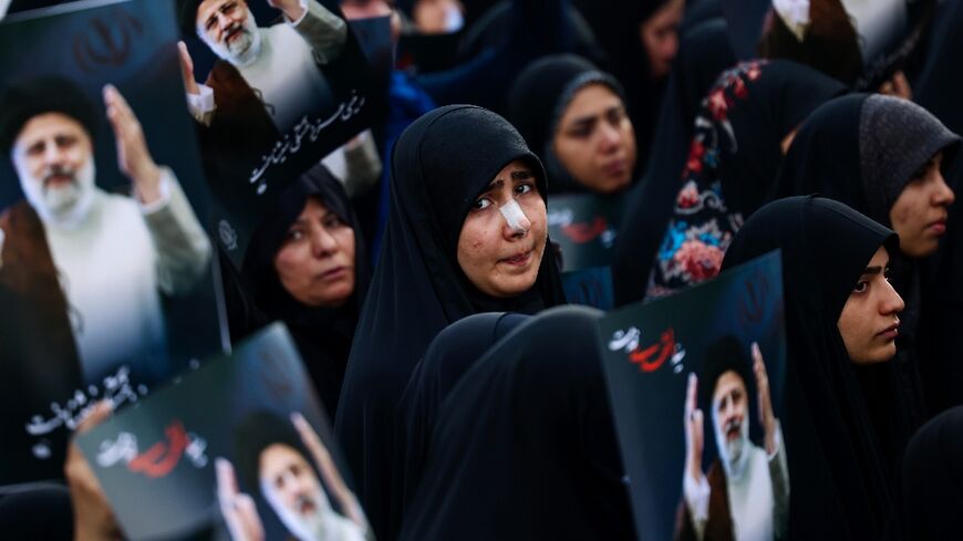 Women mourn the death of Iran's president Ebrahim Raisi at Valiasr Square in Tehran
