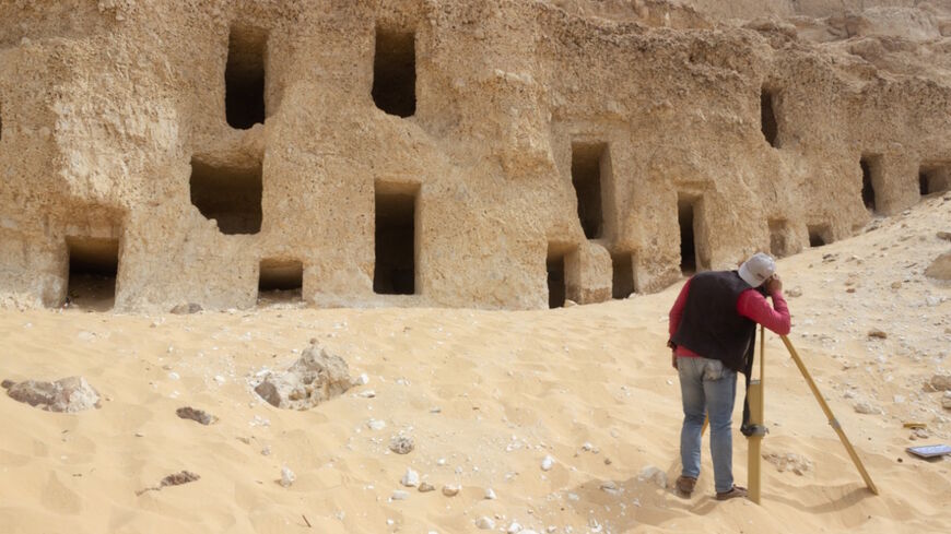 A member of a mission from Egypt's Ministry of Tourism and Antiquities is seen in a photo released May 11 in front of recently discovered tombs in Sohag. 
