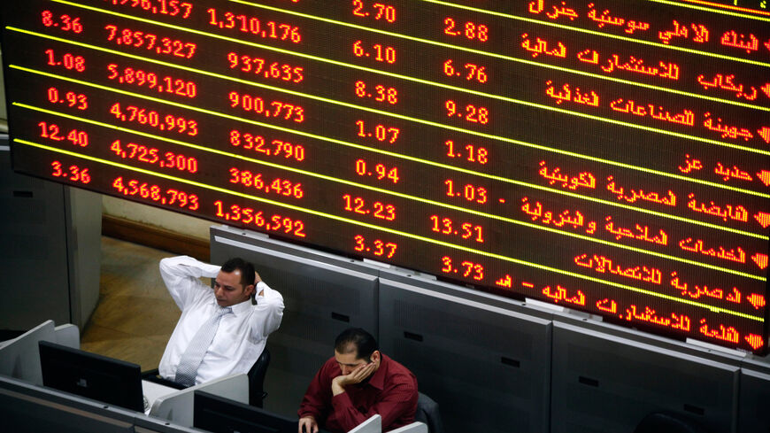 Stock market brokers gesture during trading at the Egyptian stock exchange, Cairo, Egypt, Nov. 25, 2012.