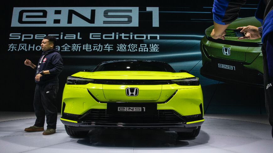 Attendees look around the Dongfeng electric Honda ENS1 on Oct. 21, 2021, in Wuhan, China. 