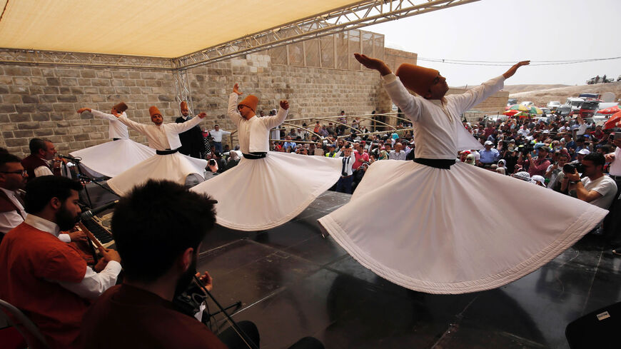 Whirling dervishes perform during a festival at the mosque of Nabi Musa, where the tomb of Prophet Moses is believed to be located, in the Judean Desert near the town of Jericho, West Bank, April 8, 2016.