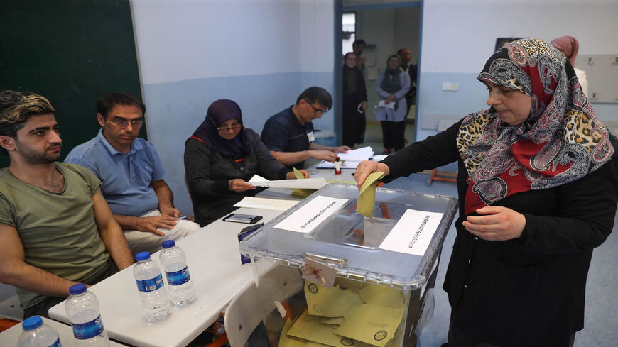 A woman casts her vote at a polling station during the mayoral elections rerun, Istanbul, Turkey, June 23, 2019.