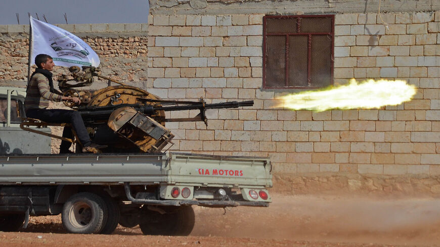 A fighter from the Free Syrian Army fires an anti-aircraft machine gun mounted on a vehicle deployed during fighting against the Islamic State near the northern village of Beraan, north of the embattled city of Aleppo, Syria, Oct. 24, 2016.