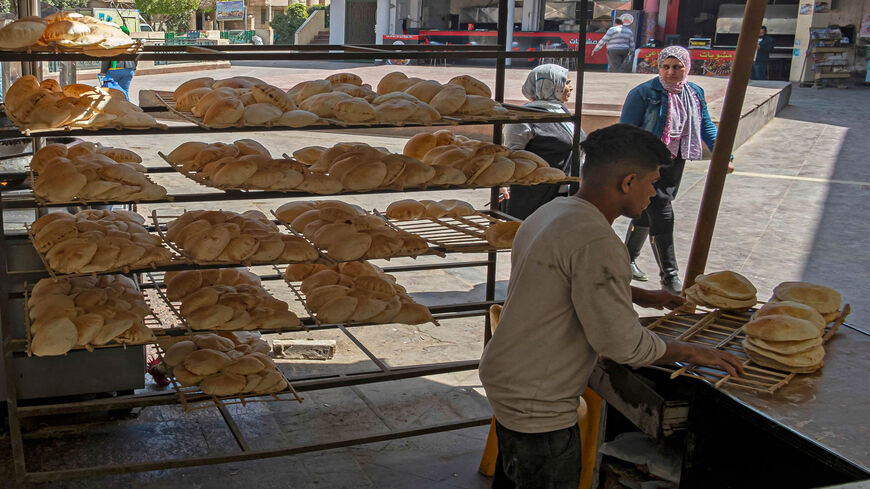 Egyptian men work in a bakery at a market in Cairo, Egypt, March 17, 2022.