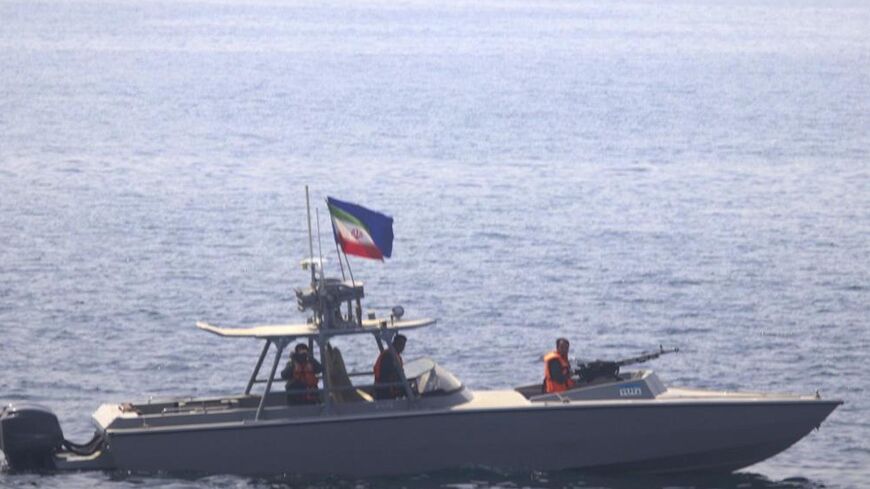 In this photo made available by the US Navy, a boat of Iran's Islamic Revolutionary Guard Corps Navy operates in close proximity to patrol coastal ship USS Sirocco.