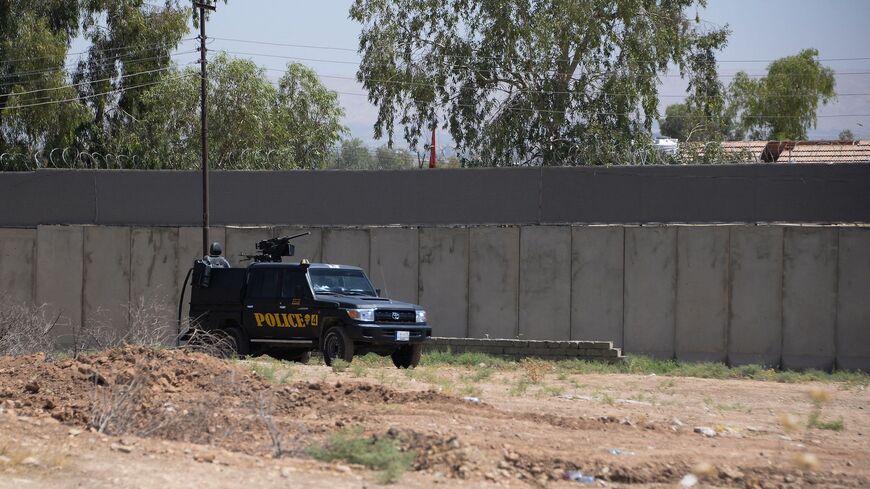 An Iraqi police vehicle secures the area of the Turkish Consulate in the northern Iraqi city of Mosul.