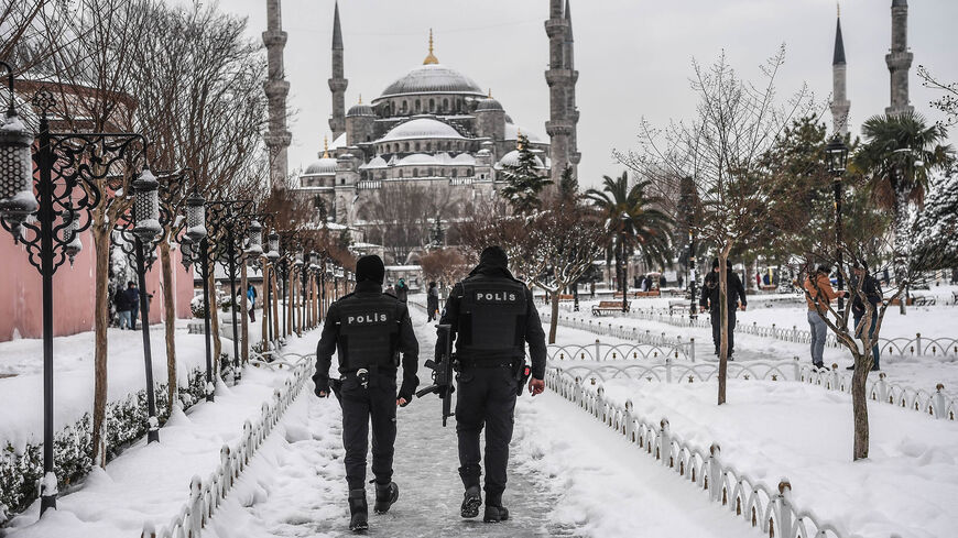 Turkish anti riot police officers patrol around the Sultan Ahmet Mosque during snowfall, Istanbul, Turkey, Jan. 8, 2017.