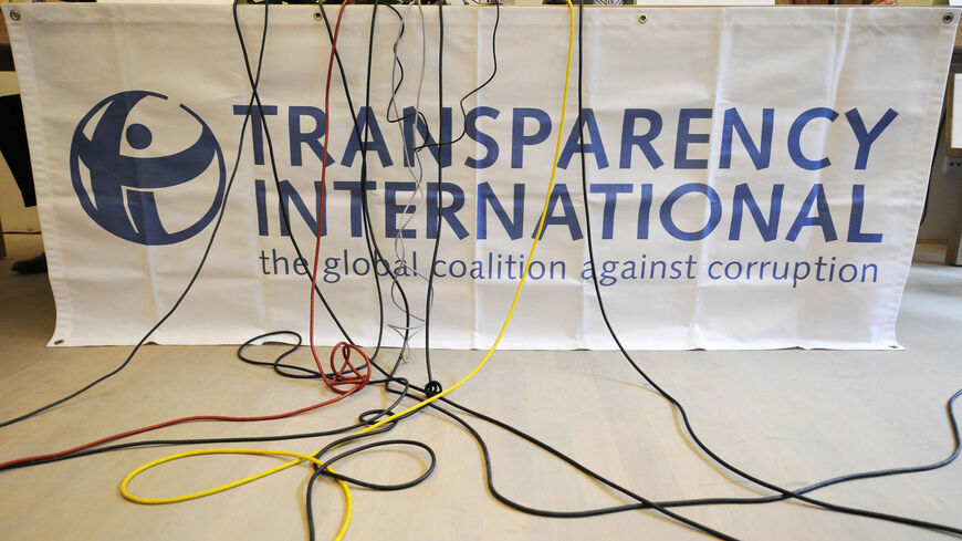 Microphone cables dangle over a logo of Transparency International during a press conference of the release of the Corruption Perceptions Index, Berlin, Germany, Sept. 23, 2008.
