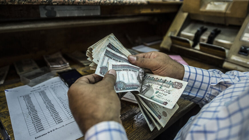 A man counts Egyptian pounds at a currency exchange shop, Cairo, Egypt, Nov. 3, 2016.
