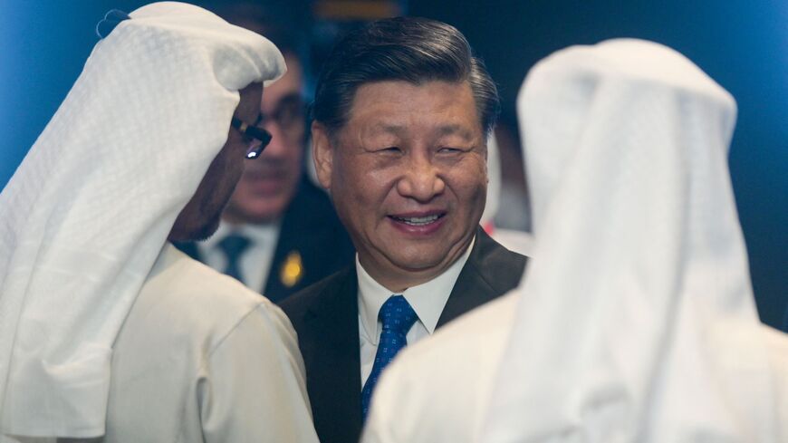 China's President Xi Jinping (C) talks with United Arab Emirates President Sheikh Mohamed bin Zayed Al-Nahyan (L) at the opening of the G20 Summit in Nusa Dua on the Indonesian resort island of Bali on November 15, 2022. (Photo by BAY ISMOYO / POOL / AFP) (Photo by BAY ISMOYO/POOL/AFP via Getty Images)