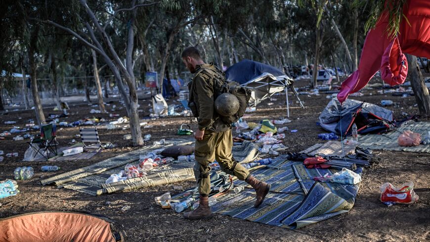 An Israeli soldier patrols near Kibbutz Re'im in southern Israel on October 12, 2023, close to the place where 270 revellers were killed by militants during the Supernova music festival on October 7.