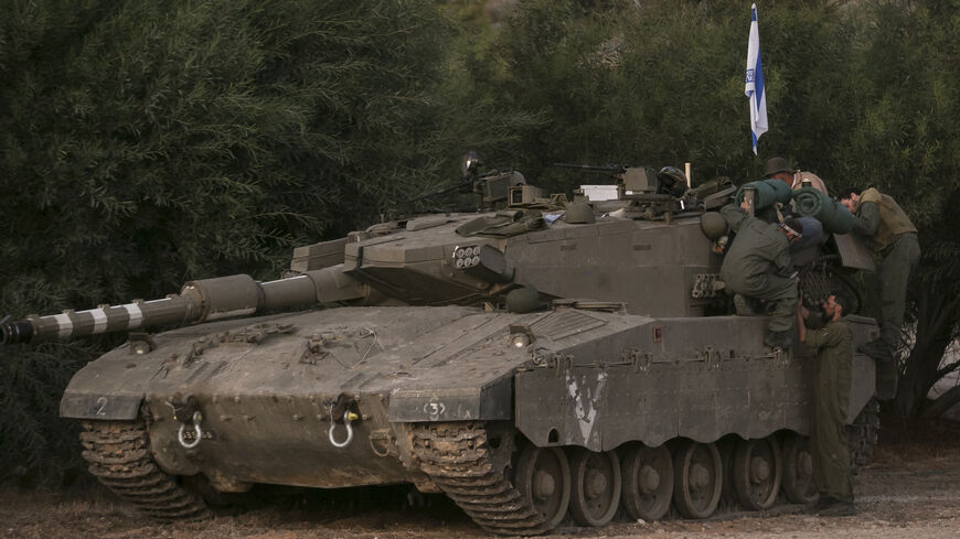 Israeli soldiers prepare a tank near the border between Israel and Lebanon on Oct. 16, 2023, in Shlomi, Israel.