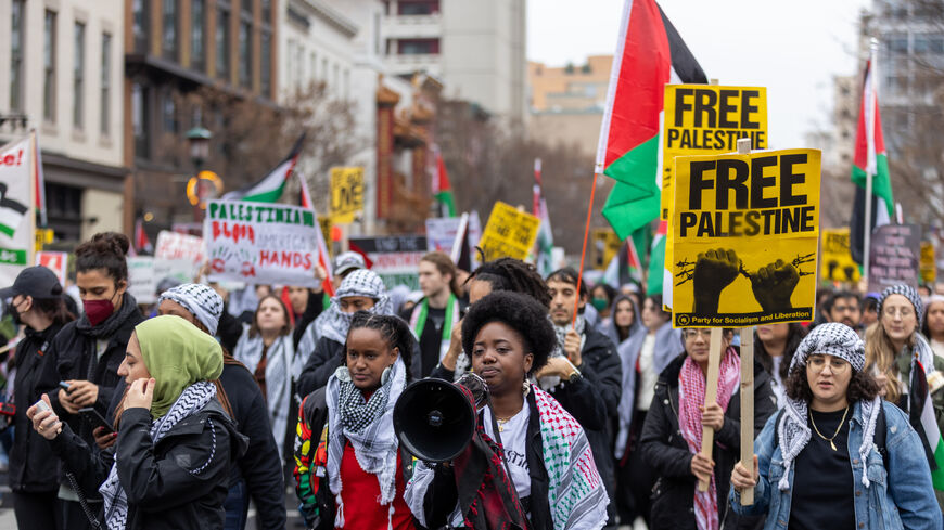 WASHINGTON, DC - DECEMBER 17: Pro-Palestinian supporters march and take over the street near Capitol One Arena, in the Chinatown area of the city on December 17, 2023 in Washington, DC. Protesters are calling for an immediate ceasefire and condemning the Israeli attacks in Gaza. (Photo by Tasos Katopodis/Getty Images)