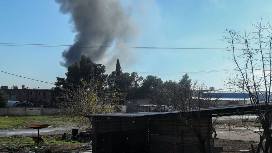 Smokes billows in Qamishli in northeastern Syria close to the Turkish border on Dec. 25, 2023, amid Turkish military strikes in the area.  