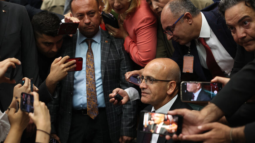 Turkish minister of Treasury and Finance Mehmet Simsek is surrounded by journalists after making a statement during the group meeting of Justice and Development (AK) Party at the Turkish Grand National Assembly in Ankara, on June 21, 2023. (Photo by Adem ALTAN / AFP) (Photo by ADEM ALTAN/AFP via Getty Images)