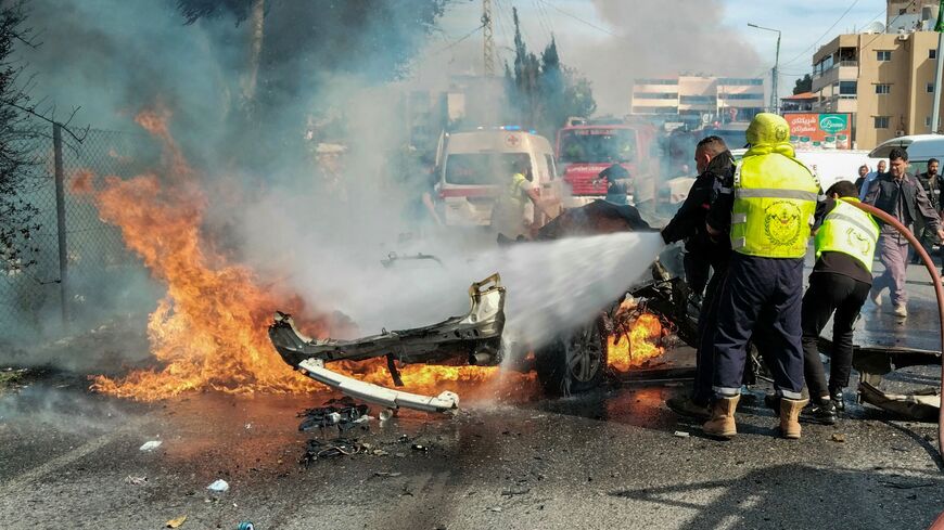 Firefighters douse a burning car after it was hit in an Israeli strike in Lebanon's southern area of Tyre on March 13, 2024, amid ongoing cross-border tensions as fighting continues between Israel and Palestinian Hamas militants in the Gaza Strip.