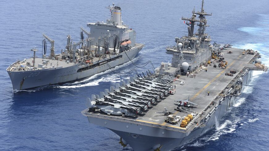 The Military Sealift Command fleet replenishment oiler USNS Laramie (T-AO 203) and the amphibious assault ship USS Kearsarge (LHD 3) conduct a replenishment-at-sea.