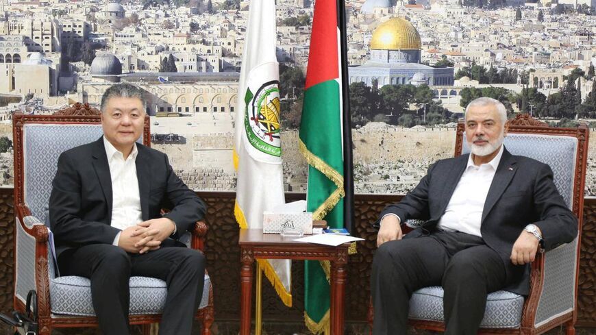Wang Kejian (left) meets Hamas political chief Ismail Haniyeh in Qatar on Oct. 17, 2023. - Hamas via Telegram
