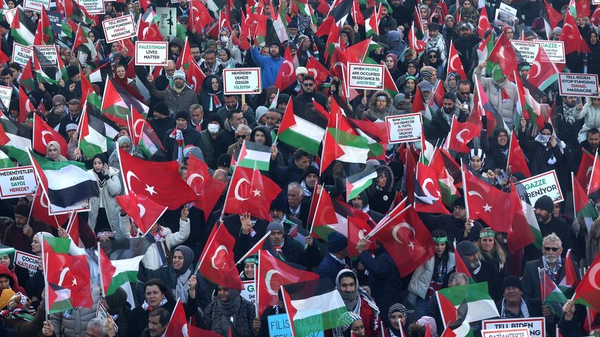 Protesters wave Turkish and Palestinian flags during a rally in solidarity with the Palestinians in Gaza, in Ankara on Dec. 24, 2023, amid ongoing battles between Israel and the Palestinian Hamas movement in the Gaza Strip. 