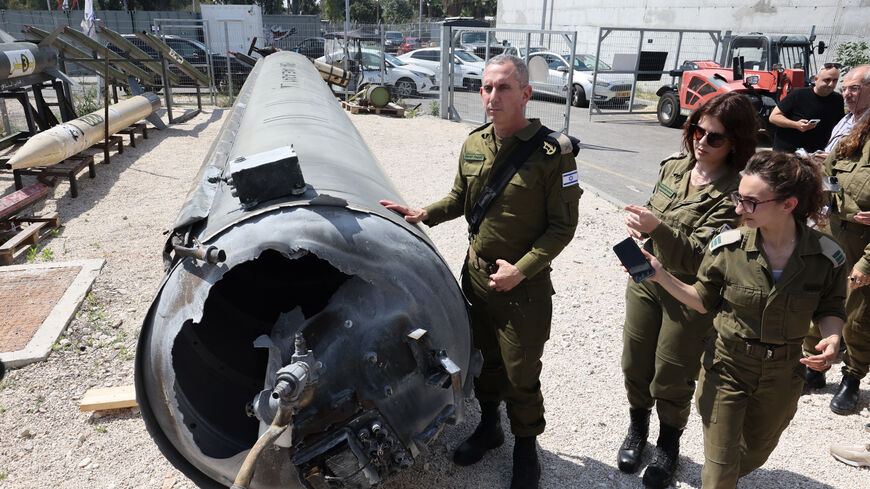 Members of the Israeli military show an Iranian ballistic missile which fell in Israel on the weekend, during a media tour at the Julis military base near the southern Israeli city of Kiryat Malachi on April 16, 2024. Iran carried out an unprecedented direct attack on Israel overnight April 13-14, using more than 300 drones, cruise missiles and ballistic missiles, in retaliation for a deadly April 1 air strike on the Iranian consulate in Damascus. Nearly all were intercepted, according to the Israeli army. 