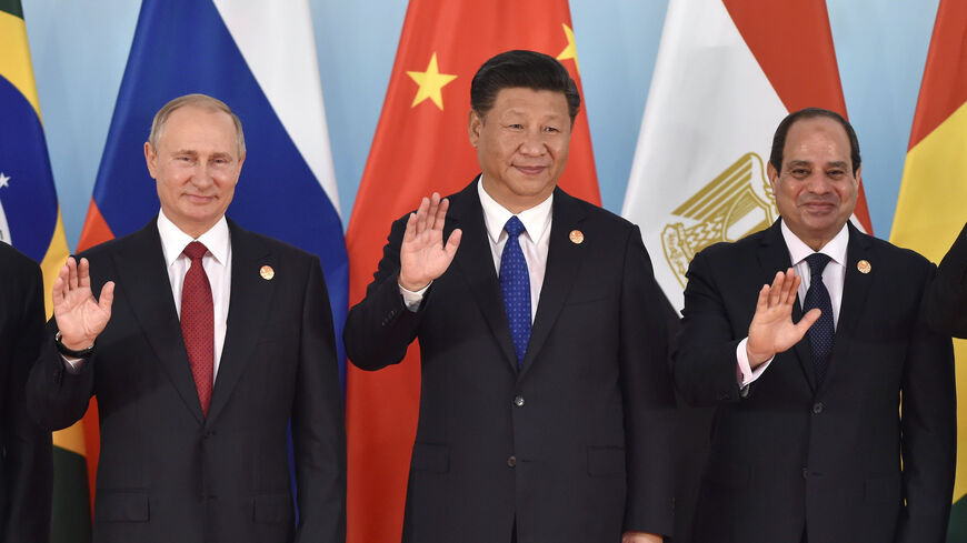 (L-R) Russian President Vladimir Putin, Chinese President Xi Jinping, Egypt's President Abdel-Fattah el-Sisi wave hands during the group photo session, a head of the Dialogue of Emerging Market and Developing Countries, on the sideline of the 2017 BRICS Summit in Xiamen, southeastern China's Fujian Province on Sept. 5, 2017. 