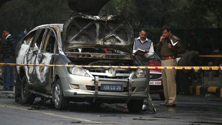Police and forensic officials examine a damaged Israeli embassy car after an explosion in New Delhi February 13, 2012. Bombers targeted staff at Israel's embassies in India and Georgia on Monday, the foreign ministry said, with a bomb going off in New Delhi but a second device in Tbilisi was defused. REUTERS/Parivartan Sharma (INDIA - Tags: POLITICS CRIME LAW CIVIL UNREST TRANSPORT TPX IMAGES OF THE DAY)