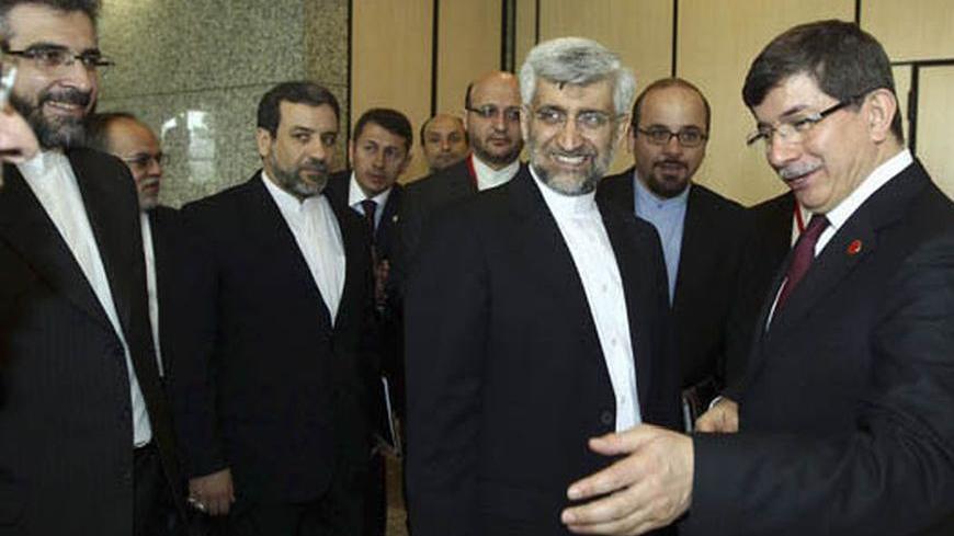 Turkey's Foreign Minister Ahmet Davutoglu (R) welcomes Iran's chief negotiator Saeed Jalili (2nd R) before their meeting in Istanbul April 14, 2012. World powers and Iran launched a new round of negotiations in Istanbul on Saturday, aiming to resolve a long-standing dispute over Tehran's nuclear programme that threatens to spark a new war in the Middle East. REUTERS/Hakan Goktepe/Pool (TURKEY - Tags: POLITICS)