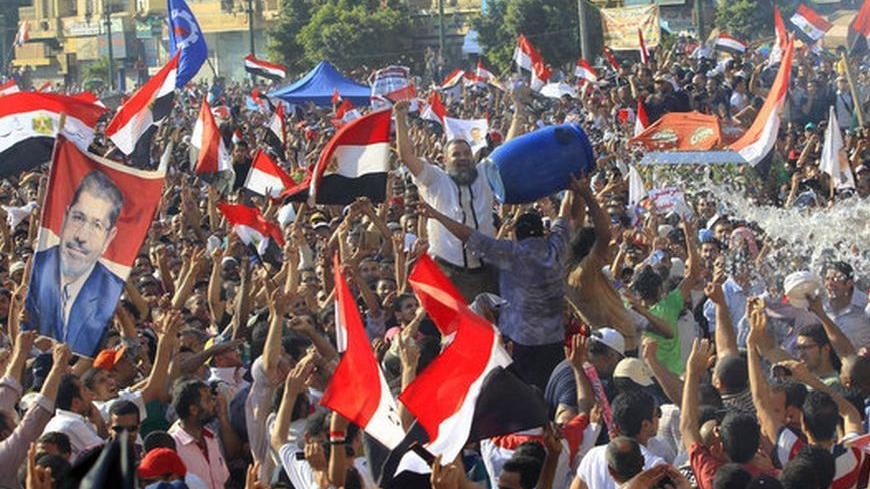 Supporters of Muslim Brotherhood's presidential candidate Mohamed Morsy celebrate his victory at the election at Tahrir Square in Cairo June 24, 2012. REUTERS/Ahmed Jadallah (EGYPT - Tags: POLITICS ELECTIONS)