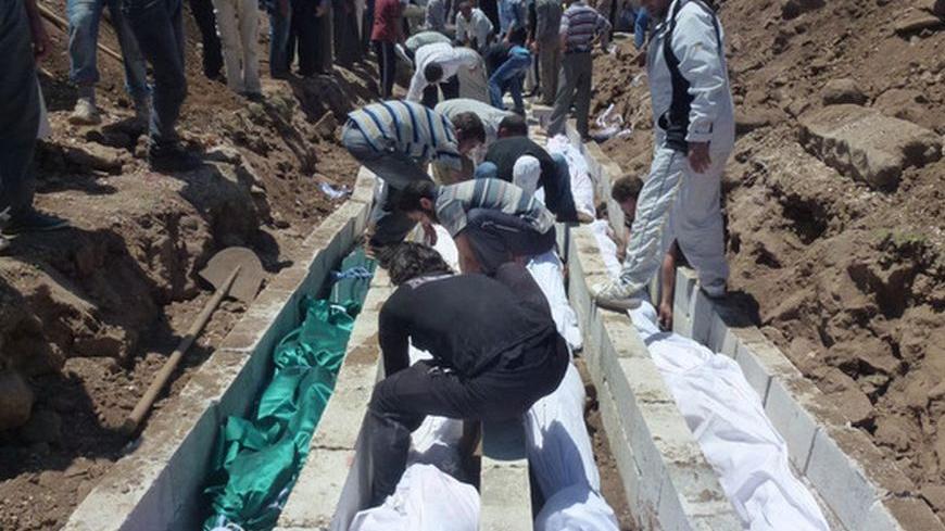 People gather at a mass burial for the victims purportedly killed during an artillery barrage from Syrian forces in Houla in this handout image dated May 26, 2012. U.N. observers in Syria have confirmed that artillery and tank shells were fired at a residential area of Houla, Syria, where at least 108 people, including many children, were killed, the U.N. chief said on Sunday in a letter to the Security Council.   REUTERS/Shaam News Network/Handout (SYRIA - Tags: POLITICS CONFLICT) FOR EDITORIAL USE ONLY. N