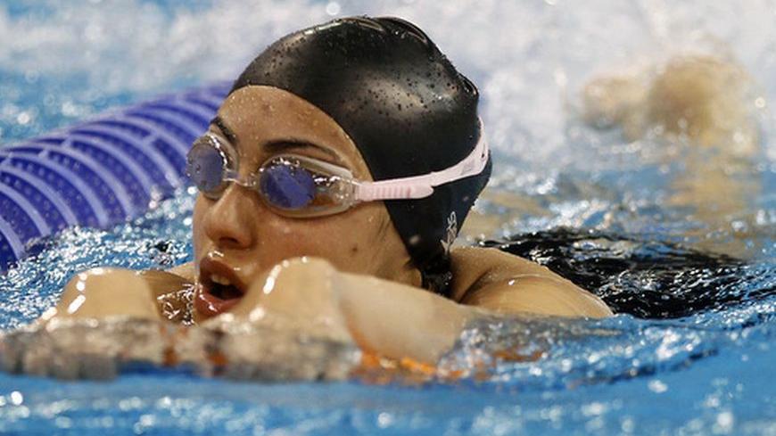 Qatar's national swimmer Nada Arkaji attends a training session in Doha March 29, 2012. Arkaji hopes to be a trailblazer for Qatar's forgotten sportswomen at the London Olympics this year even though the teenager's medal prospects are almost non-existent. The 17-year-old and sprinter Noor al-Malki will be the first women from Qatar to compete at an Olympics after the IOC handed out wildcards to the desert nation to send two female athletes to this year's Games. Picture taken March 29, 2012. To match Intervi