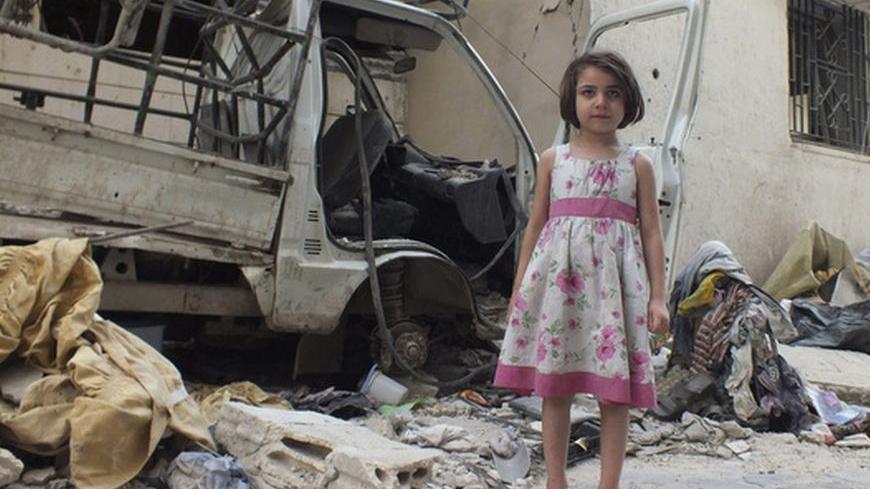 A girl wearing a pink dress poses on a street in Homs July 25, 2012. REUTERS/Yazen Homsy (SYRIA - Tags: POLITICS CIVIL UNREST CONFLICT)