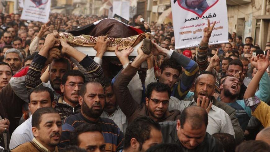 Muslim Brotherhood supporters and relatives carry the body of 15-year-old Islam Massoud during his funeral in the Egyptian town of Damanhour November 26, 2012. Massoud was killed on Sunday while attending a rally to show support for Egypt's President Mohamed Mursi and the Muslim Brotherhood when clashes broke out between supporters and protesters denouncing Mursi's decree granting him extra power, according to Brotherhood and security sources. REUTERS/Asmaa Waguih (EGYPT - Tags: POLITICS CIVIL UNREST OBITUA