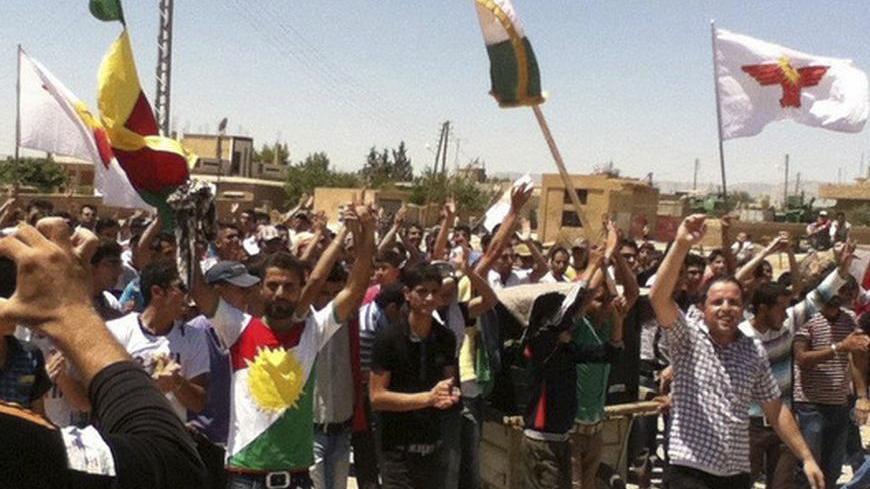 Demonstrators hold Kurdish flags during a protest against Syrian President Bashar al-Assad in Al-Hasakah July 20, 2012. Picture taken July 20, 2012. REUTERS/Shaam News Network/Handout   (SYRIA  - Tags: POLITICS CIVIL UNREST) FOR EDITORIAL USE ONLY. NOT FOR SALE FOR MARKETING OR ADVERTISING CAMPAIGNS. THIS IMAGE HAS BEEN SUPPLIED BY A THIRD PARTY. IT IS DISTRIBUTED, EXACTLY AS RECEIVED BY REUTERS, AS A SERVICE TO CLIENTS