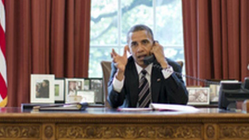 U.S. President Barack Obama speaks on the phone with Israel's Prime Minister Benjamin Netanyahu, in the Oval Office in this September 28, 2012 White House handout photograph. Obama and Netanyahu expressed solidarity on the goal of preventing Iran from acquiring a nuclear weapon, the White House said on Friday, amid signs of easing tensions over their differences on how to confront Tehran. REUTERS/Pete Souza/The White House/Handout  (UNITED STATES - Tags: POLITICS TPX IMAGES OF THE DAY) FOR EDITORIAL USE ONL