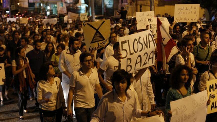 Lebanese protesters hold banners during the "White March" against the violence and the political struggle in the country, organised by Lebanese civil society groups, in Beirut October 25, 2012.  REUTERS/Jamal Saidi (LEBANON - Tags: POLITICS CIVIL UNREST)