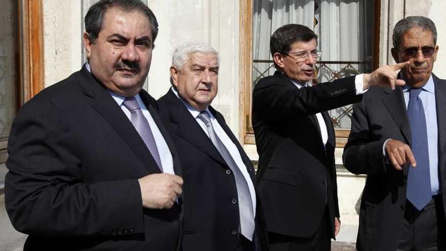 Foreign Ministers Hoshiyar Zebari of Iraq, Walid al-Moualem of Syria and Ahmet Davutoglu of Turkey, and Secretary General of the Arab League Amr Moussa (R) chat before their meeting at the Ottoman-era Ciragan Palace in Istanbul September 17, 2009. REUTERS/Osman Orsal (TURKEY POLITICS)