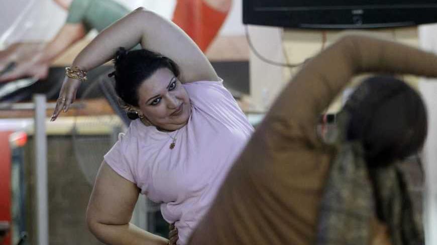 Women work out at a gym in Baghdad December 2, 2012. Inssam, the owner of the gym, said she had noticed an increase in the number of women working out at the gym recently, a trend which she attributed to the influx of Western television programmes into the country after 2003. Picture taken December 2, 2012. REUTERS/Thaier al-Sudani/ (IRAQ - Tags: SOCIETY)