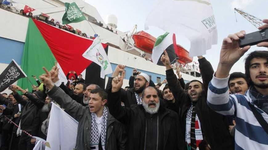 Supporters of Hamas' Gaza leader Ismail Haniyeh shout slogans against Israel in front of the cruise liner Mavi Marmara in Istanbul January 2, 2012.  REUTERS/Osman Orsal (TURKEY - Tags: POLITICS)