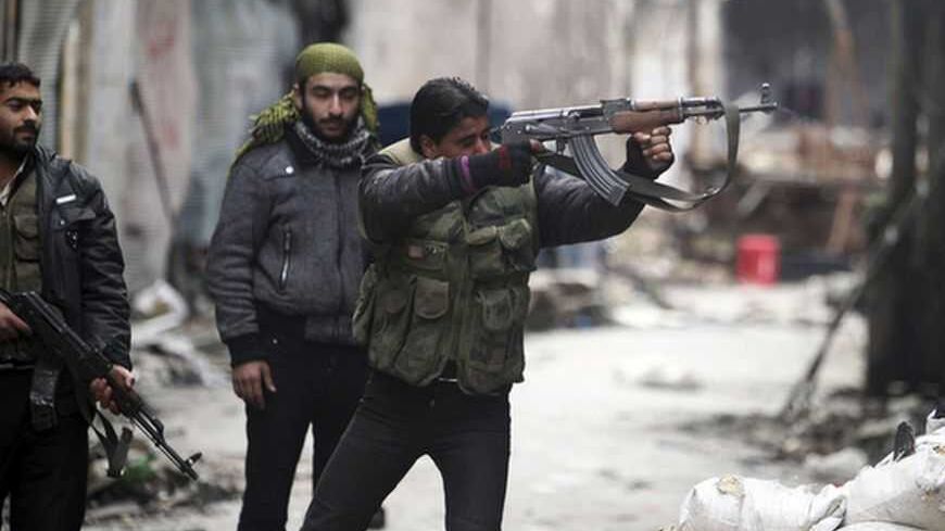 A Free Syrian Army fighter fires his weapon towards positions occupied by forces loyal to Syria's President Bashar al-Assad in the old city of Aleppo January 7, 2013. REUTERS/Muzaffar Salman (SYRIA - Tags: CONFLICT POLITICS CIVIL UNREST TPX IMAGES OF THE DAY)