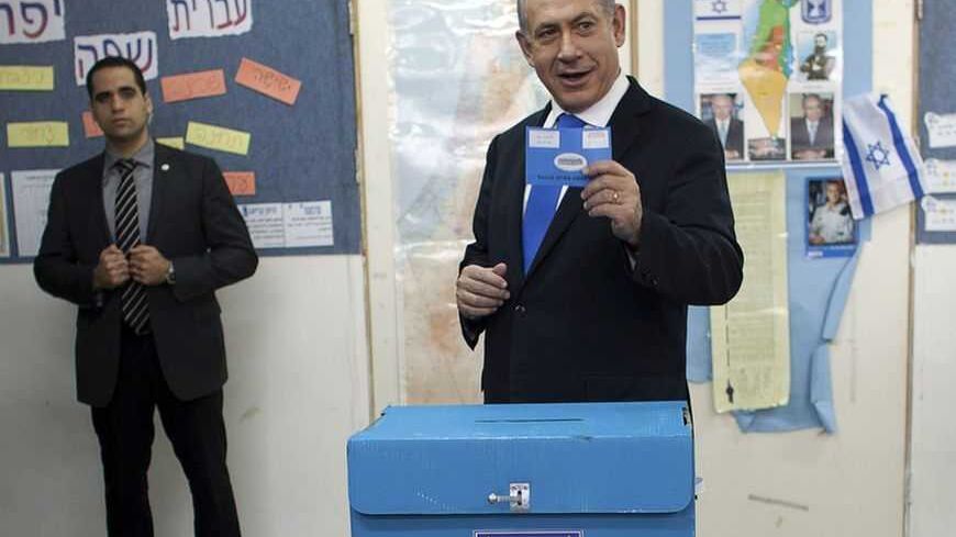 Israel's Prime Minister Benjamin Netanyahu casts his ballot for the parliamentary election at a polling station in Jerusalem January 22, 2013. Israelis voted on Tuesday in an election widely expected to win Netanyahu a third term in office, pushing the Jewish State further to the right, away from peace with Palestinians and towards a showdown with Iran. REUTERS/Uriel Sinai/Pool (JERUSALEM - Tags: POLITICS ELECTIONS TPX IMAGES OF THE DAY)
