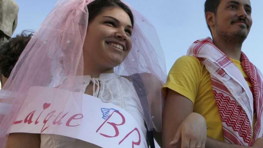 Protesters, acting as bride and groom, take part in a demonstration to demand for the legalisation of civil marriages, in front of the government palace and parliament in Beirut May 15, 2011. REUTERS/Jamal Saidi  (LEBANON - Tags: CIVIL UNREST POLITICS SOCIETY RELIGION) - RTR2MGL0