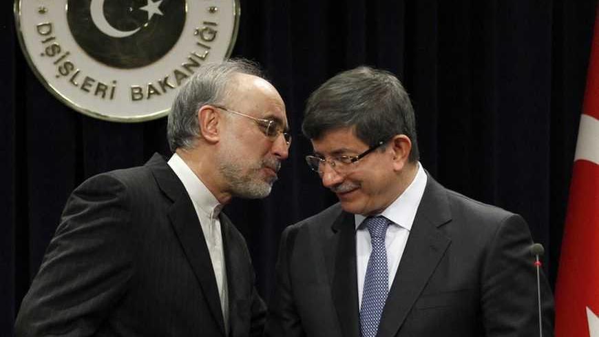 Turkey's Foreign Minister Ahmet Davutoglu and his Iranian counterpart Ali Akbar Salehi (L) attend a news conference in Ankara January 19, 2012. Iran's foreign minister warned Arab neighbours on Thursday not to put themselves in a "dangerous position" by aligning themselves too closely with the United States in the escalating dispute over Tehran's nuclear activity. Iran has threatened to close the Strait of Hormuz, used for a third of the world's seaborne oil trade, if pending Western moves to ban Iranian cr