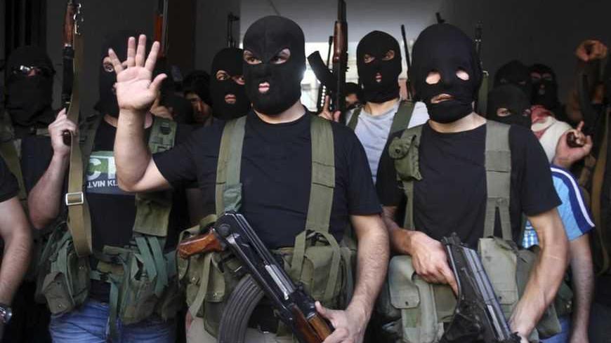 Shi'ite masked gunmen from the Meqdad clan, gather at the Meqdad family's association headquarters in the southern suburbs in Beirut, August 15, 2012. A Shi'ite Muslim clan in Lebanon has abducted a Turkish businessman and several Syrians it says are rebel fighters in retaliation for the kidnapping of one of their relatives by the rebel Free Syrian Army in Damascus. REUTERS/Khalil Hassan    (LEBANON - Tags: POLITICS CIVIL UNREST TPX IMAGES OF THE DAY) - RTR36V96
