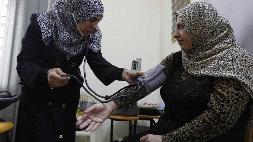 An Iraqi instructor teaches a widow how to use a blood pressure device at widows training and development center in Baghdad, November 12, 2012. Widows work on sewing machine at a widows training and development center in Baghdad, November 13, 2012. Baghdad's Widows Training and Development Centre offers training to improve employment prospects for widows and help enable them to set up their own businesses to support their families. Established in 2006 and funded by a number of international charities, the c