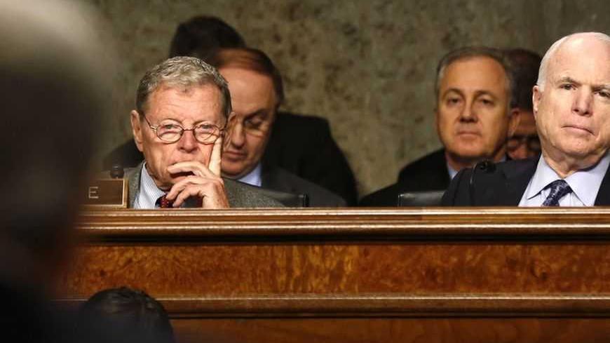U.S. Senators  Carl Levin (D-MI), James Inhofe (R-OK) and John McCain (R-AZ) (L-R) listen as former Senator Chuck Hagel (foreground) testifies during a Senate Armed Services Committee hearing on Hagel's nomination to be Defense Secretary, on Capitol Hill in Washington, January 31, 2013.  REUTERS/Larry Downing (UNITED STATES  - Tags: POLITICS MILITARY)   - RTR3D711