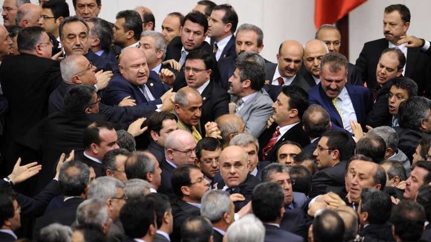 Members of Turkish parliament from the ruling AK Party (AKP) and Republican People's Party (CHP) scuffle during a debate at the parliament in Ankara late February 8, 2012. REUTERS/Stringer (TURKEY - Tags: POLITICS CIVIL UNREST) - RTR2XIJG