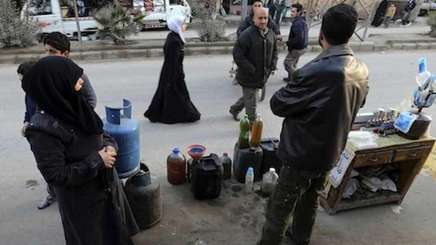 A man selling petrol and gas waits for clients in Ain Tarma neighbourhood, Damascus January 23, 2013.   REUTERS/Goran Tomasevic (SYRIA - Tags: CIVIL UNREST POLITICS BUSINESS EMPLOYMENT ENERGY) - RTR3CUPA